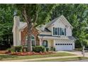 Beautifully landscaped two-story home with brick facade and a well-maintained lawn in a Gathering-friendly neighborhood at 3388 Washington Cmns Nw Ave, Kennesaw, GA 30144