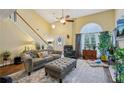 Bright living room with high ceilings, large windows, neutral walls, hardwood floors and comfortable seating at 3388 Washington Cmns Nw Ave, Kennesaw, GA 30144