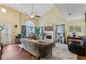 Elegant living room with vaulted ceiling, fireplace, hardwood floors, and plenty of natural light at 3388 Washington Cmns Nw Ave, Kennesaw, GA 30144
