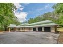 Side view of the house and driveway, including a three-car garage at 379 Bohannon Rd, Grantville, GA 30220