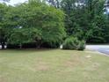 Lush front yard featuring mature trees and landscaping at 5517 Rock Shoals Way, Atlanta, GA 30349