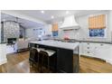 Modern kitchen with island, stainless steel appliances, white cabinets, and hardwood flooring at 1146 Cumberland Ne Rd, Atlanta, GA 30306