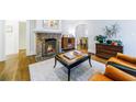 Cozy living room showcasing a brick fireplace, hardwood floors, and stylish decor at 1146 Cumberland Ne Rd, Atlanta, GA 30306
