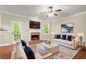 Inviting living room with a brick fireplace, ceiling fan, and plenty of natural light at 212 Ranier Court, Canton, GA 30114