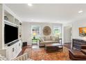 Bright living room with hardwood floors, built-in shelves, and a comfortable seating arrangement at 3262 Mitsy Forest Way, Marietta, GA 30068