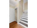 Entryway featuring wood floors, white trim, and a staircase at 5159 Wellsley Bnd, Alpharetta, GA 30005