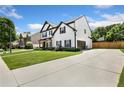 Spacious home with a long driveway and attached two-car garage in a lush green neighborhood at 247 Creek View Ln, Acworth, GA 30102