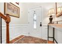 Bright foyer with hardwood floors, decorative wainscoting, and elegant console table at 247 Creek View Ln, Acworth, GA 30102