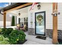 Inviting front porch with rocking chairs, decorative wreath, and charming 'Welcome' sign at 247 Creek View Ln, Acworth, GA 30102