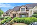 View of home featuring well-maintained yard, stone walkway, and welcoming front door at 2551 Village Creek Se Lndg, Atlanta, GA 30316