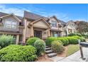 Exterior view of townhome with steps, landscaped yard, and a welcoming entrance at 2551 Village Creek Se Lndg, Atlanta, GA 30316