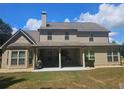 Back exterior elevation showing a spacious yard and covered patio perfect for entertaining at 124 Archstone Sq, Mcdonough, GA 30253