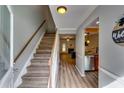 Inviting foyer with beautiful hardwood floors, staircase, and seamless transition to the kitchen at 2972 Aspen Woods Entry, Atlanta, GA 30360