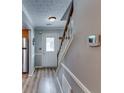 Inviting entryway features hardwood floors, staircase, and access to various living spaces at 2972 Aspen Woods Entry, Atlanta, GA 30360