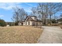 Charming one-story home featuring Tudor-style accents and a concrete driveway at 108 Deer Creek Run, Moreland, GA 30259