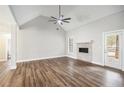 Spacious living room boasts a ceiling fan, fireplace, wood floors, and a bright, airy ambiance at 108 Deer Creek Run, Moreland, GA 30259