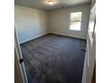 Cozy bedroom featuring neutral walls, plush carpeting, and a window for natural light at 3806 Lockaby Way, Lawrenceville, GA 30044