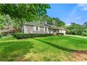 Well-maintained home featuring lush green lawn and mature landscaping at 57 Fair Oaks Se Dr, Conyers, GA 30094
