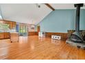 Open-concept living room with hardwood floors, fireplace, and vaulted ceiling at 57 Fair Oaks Se Dr, Conyers, GA 30094