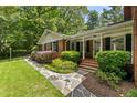 Beautiful brick home with black shutters, stone walkway, and manicured lawn at 4243 Mcclatchey Ne Cir, Atlanta, GA 30342