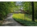 A long driveway leads up to a traditional brick home surrounded by lush greenery at 4243 Mcclatchey Ne Cir, Atlanta, GA 30342