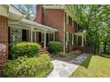Brick home with manicured landscaping, a stone walkway, and covered front entry at 4243 Mcclatchey Ne Cir, Atlanta, GA 30342
