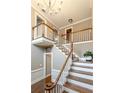 Grand foyer featuring hardwood floors, staircase with wood railings, and a chandelier at 110 Amsterdam Dr, Lilburn, GA 30047