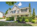 Beautiful two story brick home featuring a manicured front yard and covered porch at 2304 Mitford Ct, Dacula, GA 30019