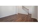 Open-concept living room features hardwood floors throughout and views of staircase at 80 Hampton Ter, Dallas, GA 30157