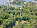 Aerial view of a single Gathering home located near a marina and lakefront community surrounded by lush green trees at 8443 Marina Bay Ct, Jonesboro, GA 30236