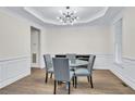 Formal dining room with wood flooring, designer lighting, and ample space for entertaining guests at 870 River Cliff Ct, Suwanee, GA 30024
