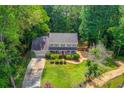 Expansive property featuring a well-maintained lawn, mature trees, and a long driveway at 905 Foxfire Dr, Lawrenceville, GA 30044