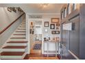 Inviting foyer with hardwood floors, staircase, and tastefully decorated walls at 905 Foxfire Dr, Lawrenceville, GA 30044
