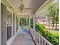 Cozy porch with a swing, offering a tranquil spot to relax and enjoy the outdoors at 905 Foxfire Dr, Lawrenceville, GA 30044