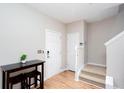 Bright entryway with wood floors, a staircase, and a dark table with two chairs at 1122 Cotton Gin Dr, Woodstock, GA 30188