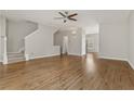 Open-concept living room with gleaming hardwood floors and staircase at 1122 Cotton Gin Dr, Woodstock, GA 30188
