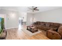 Cozy living room with hardwood floors, a large sofa, and a view into the dining room at 1122 Cotton Gin Dr, Woodstock, GA 30188