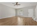 Bright living room featuring hardwood floors, a ceiling fan and neutral walls at 1122 Cotton Gin Dr, Woodstock, GA 30188
