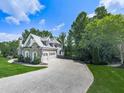Elegant home with three car garage and ample parking surrounded by lush green trees and manicured lawn at 237 Libby Ln, Canton, GA 30115