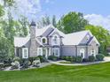 Charming two-story home with stone accents, arched windows, and well-maintained landscaping at 237 Libby Ln, Canton, GA 30115