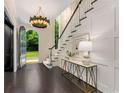 Elegant foyer with a chandelier, paneled walls, and a grand staircase at 3773 Randall Se Rd, Atlanta, GA 30339