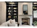 Cozy living room with a stone fireplace and custom built-in shelving at 3773 Randall Se Rd, Atlanta, GA 30339