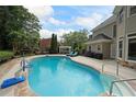 Backyard pool and patio area is great for entertaining or enjoying the sun at 5617 Asheforde Ln, Marietta, GA 30068