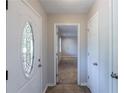 Bright foyer with decorative glass front door and tiled flooring at 1406 Windy Ridge Se Ct, Conyers, GA 30013