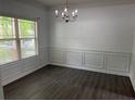 Bright dining room with gray floors, decorative trim, and a large window at 519 Granite Nw Ct, Lawrenceville, GA 30044