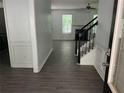 Inviting entryway with modern gray floors, white walls, and a view into the living room at 519 Granite Nw Ct, Lawrenceville, GA 30044