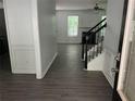 Inviting foyer with stylish gray wood-look flooring and a staircase leading to the upper level at 519 Granite Nw Ct, Lawrenceville, GA 30044