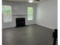 Open living room with gray floors, fireplace, and bright windows at 519 Granite Nw Ct, Lawrenceville, GA 30044