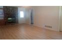 Inviting living room featuring a stone fireplace and modern laminate flooring at 61 Maxie Ln, Dallas, GA 30157