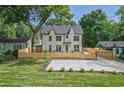 Newly built two-story home boasting a well-kept lawn, modern fence and parking pad at 2809 Glenwood Se Ave, Atlanta, GA 30317